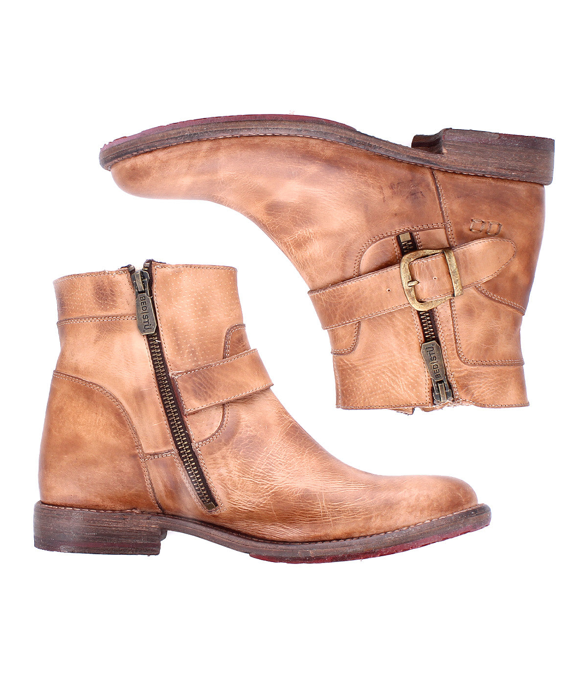 Pair of tan "Becca" leather ankle boots by Bed|Stü, featuring a sleek leather shaft, side zippers, decorative ankle buckle straps, and low stacked heels, shown from side views on a white background.