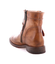 The Becca by Bed|Stü is a brown leather ankle boot featuring a sturdy leather shaft, side zipper, low heel, and visible stitching, displayed from a rear three-quarter angle on a white background.