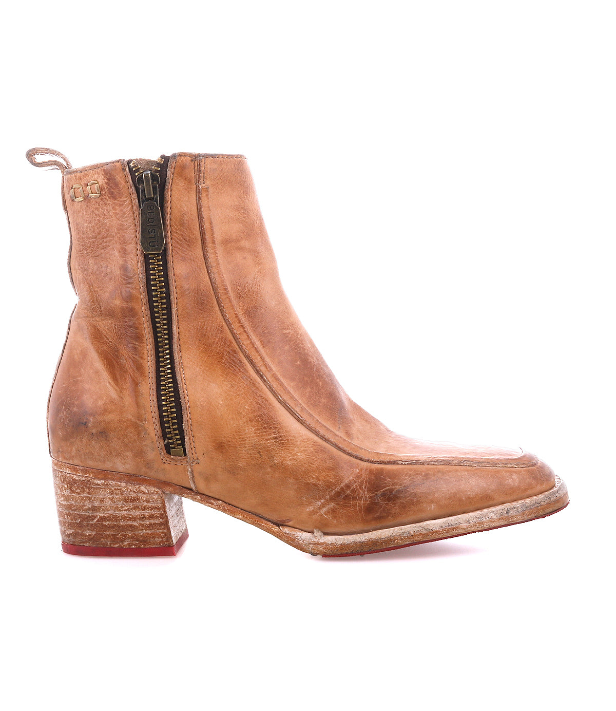 The Bed|Stü Bitsy boot is a light brown leather ankle boot featuring a side zipper, stacked heel, and a slightly worn finish.