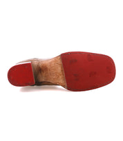 The image shows the bottom of a Bed|Stü Bitsy leather dress shoe, featuring a red sole with a stacked heel; the center section is worn and brown, while the toe and heel sections remain red and appear less worn.