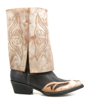 A single "Blind" western boot by Bed|Stü, handcrafted with a tan upper featuring stitched designs and a black pointed toe with tan accents, is displayed in profile against a white background.