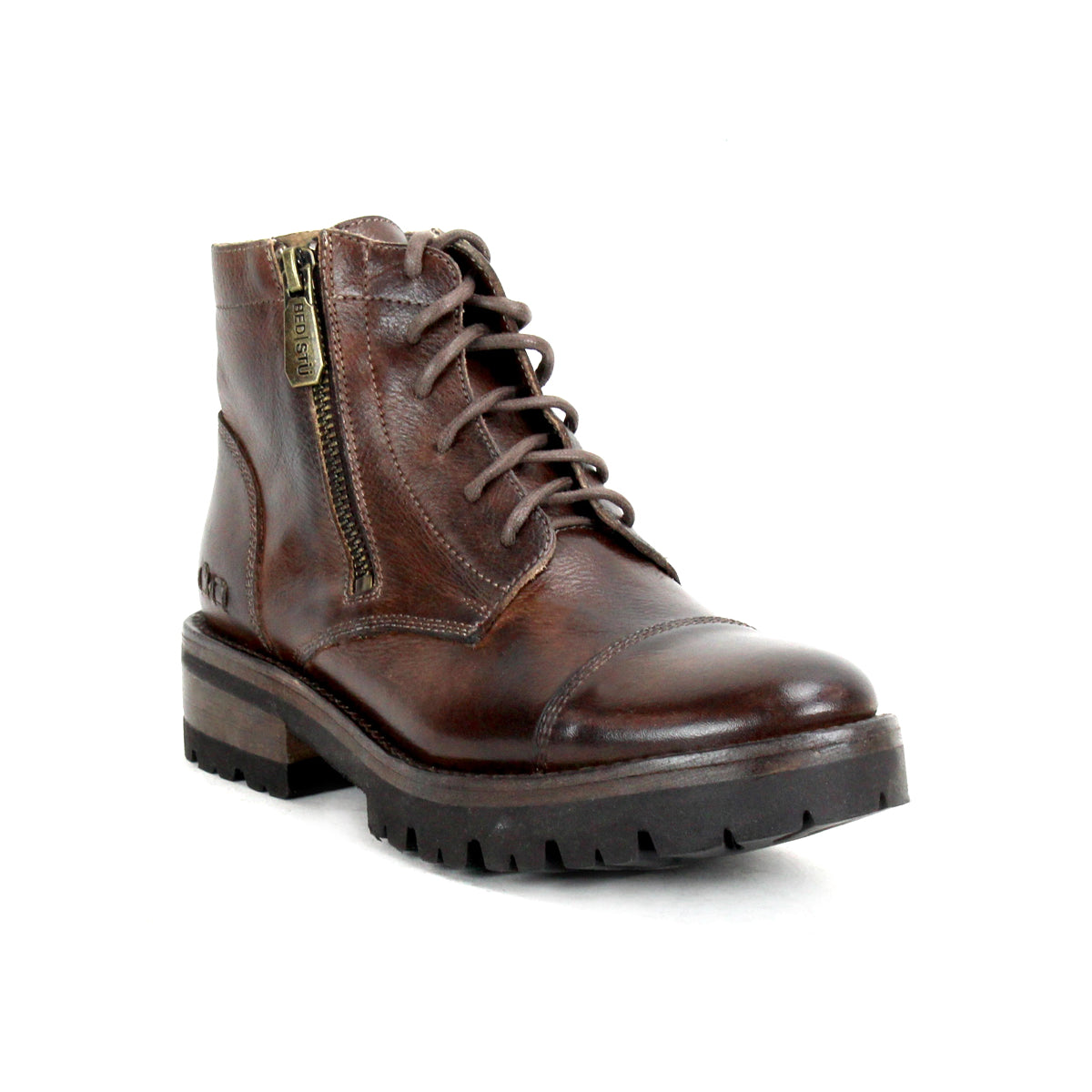 The Bed|Stü Bonnie IV is a brown leather lace-up combat boot featuring a minimalist silhouette, side zipper, rugged sole, and low heel, displayed on a white background.