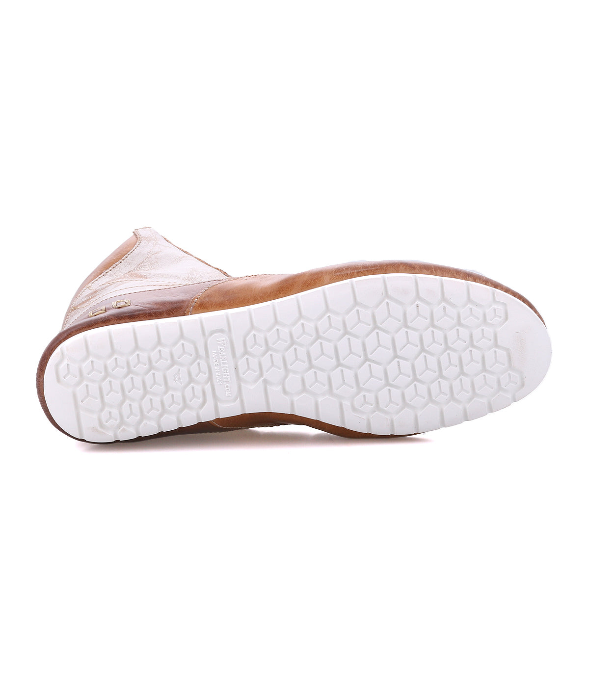 A tan Breath boot by Bed|Stü shown from below, showcasing a white rubber sole with a hexagonal tread pattern reminiscent of the bold grip often found on statement sneakers.