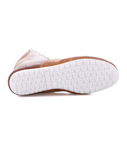 A tan Breath boot by Bed|Stü shown from below, showcasing a white rubber sole with a hexagonal tread pattern reminiscent of the bold grip often found on statement sneakers.
