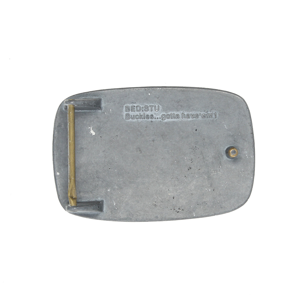 Rectangular rugged metal belt buckle, back view, with "Bed|Stü 95 Buckle...gotta have 'em!" engraved on the surface.
