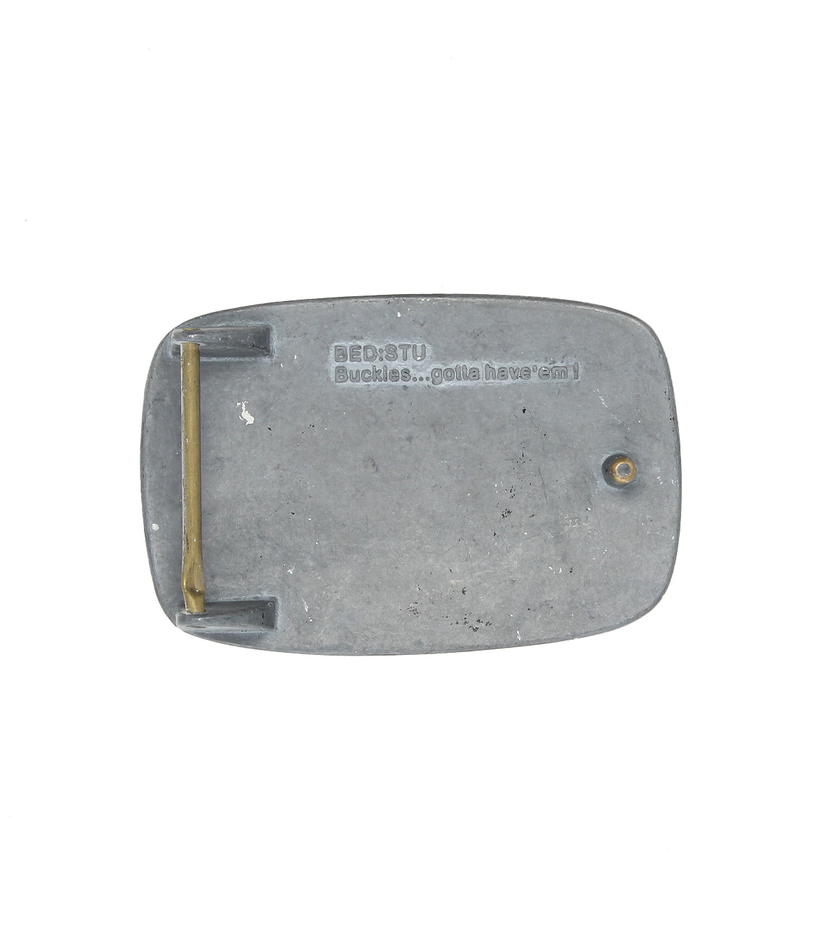 Rectangular rugged metal belt buckle, back view, with "Bed|Stü 95 Buckle...gotta have 'em!" engraved on the surface.