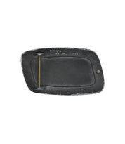 The Elevate Buckle by Bed|Stü is a rectangular distressed belt buckle in black, featuring a brass bar on the backside and subtle wear along the edges, displayed against a white background.