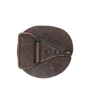 The Bed|Stü Greek Cross Buckle, a vintage-inspired round metal belt buckle with an oxidized finish, features three visible rivets and a hinged clasp, and is displayed against a white background.