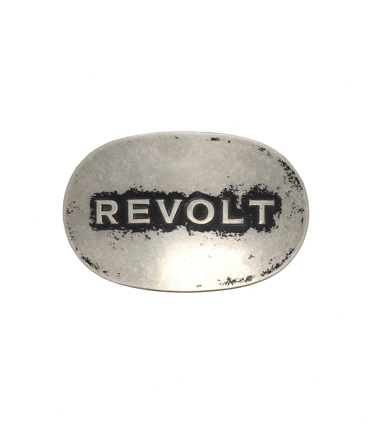 Bed|Stü’s Revolt Buckle features an oval silhouette and a silver-tone finish, with “REVOLT” boldly engraved in uppercase letters; its worn, aged surface enhances the buckle’s unmistakable punk and rebellious appeal.