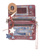 The Cadence by Bed|Stü is a distressed 3-in-1 leather wallet crafted from vegetable-tanned leather, designed with zippers, card slots, star-shaped keychains, a long strap for crossbody clutch styling, and a convenient wristlet—displayed on a white background.