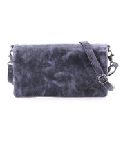 The Cadence by Bed|Stü is a rectangular crossbody clutch in dark blue, crafted from textured vegetable-tanned leather and featuring an adjustable strap, displayed against a white background.