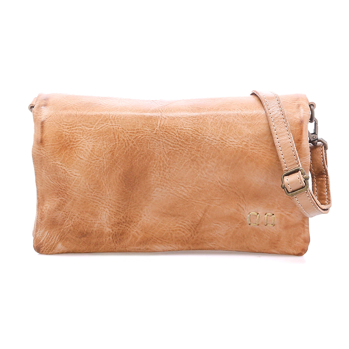 The Cadence crossbody clutch by Bed|Stü is crafted from vegetable-tanned leather in a light brown hue, featuring an adjustable strap and a subtle textured finish, displayed against a white background.