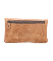 The Cadence by Bed|Stü is a rectangular tan crossbody clutch made from vegetable-tanned leather, featuring a prominent front zipper pocket and shown against a white background.