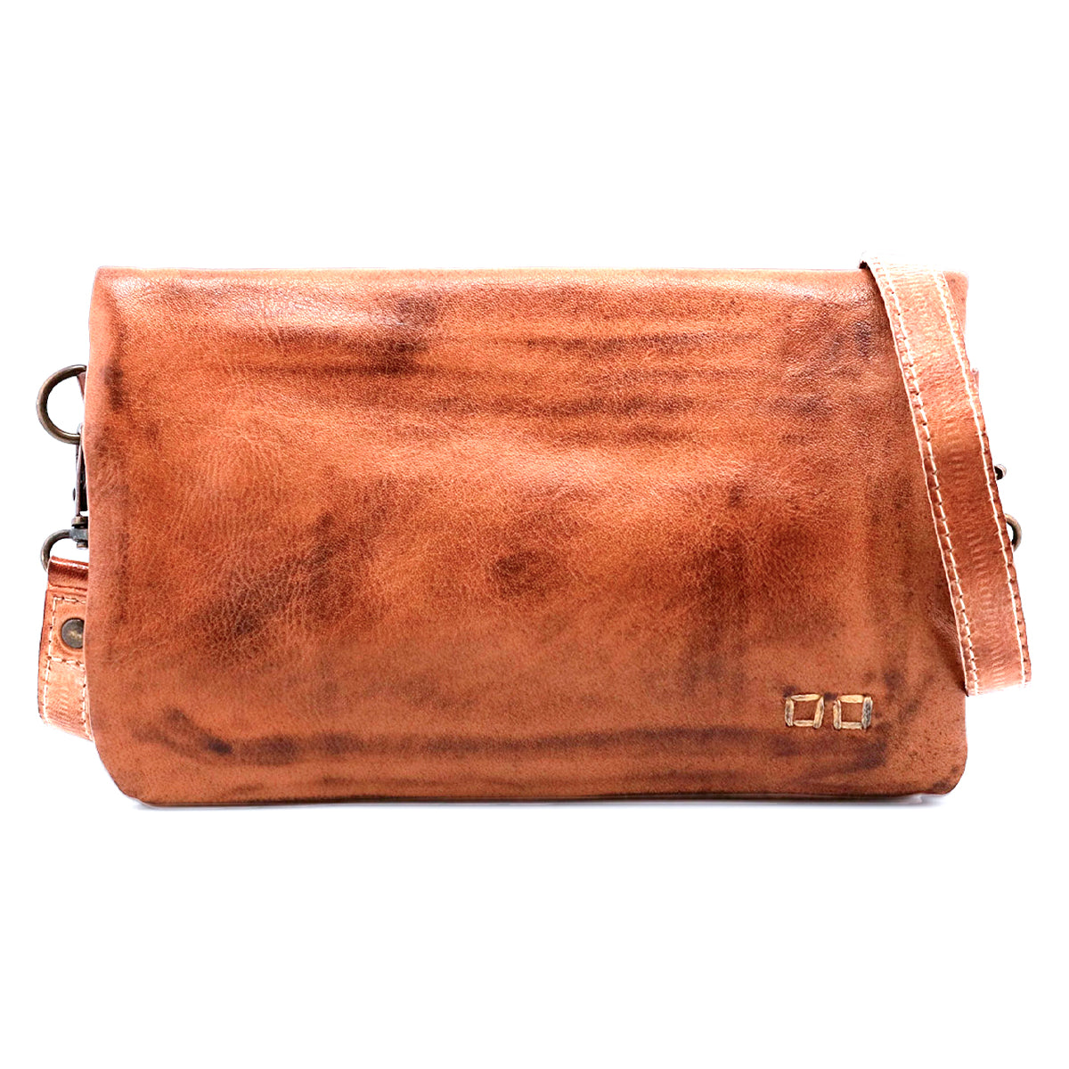 The Cadence crossbody clutch by Bed|Stü is a rectangular brown bag crafted from premium vegetable-tanned leather, featuring a long strap and a small metallic logo detail in the bottom right corner.