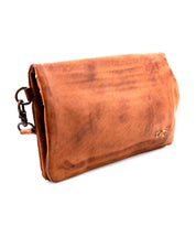 The Cadence clutch by Bed|Stü, crafted from brown vegetable-tanned leather and finished with a metal clasp, is shown against a white background.
