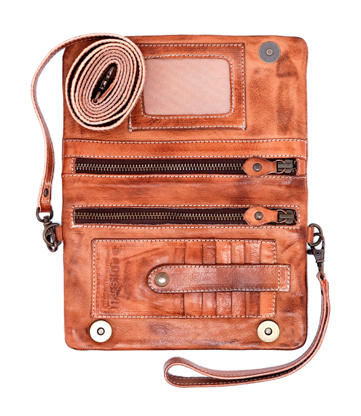 The Cadence crossbody clutch by Bed|Stü, crafted from vegetable-tanned brown leather, features multiple zippered compartments, card slots, a clear ID window, and an attached rolled wrist strap. Shown open on a white background.