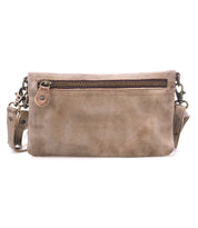 The Cadence crossbody bag by Bed|Stü features brown vegetable-tanned leather, a front zipper pocket, and an adjustable strap, displayed against a white background.