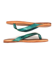 Two lightweight Calma sandals by Bed|Stü, in green and tan leather, are placed parallel to each other against a white background, with the soles facing outward.