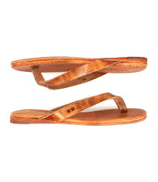 A pair of Bed|Stü Calma brown leather flip-flop sandals are pictured side by side on a white background, shown from a side view.