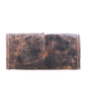 The Bed|Stü Canton 2-in-1 clutch bag in worn brown leather features visible creases and scuffs, shown against a white background.