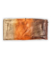 The Bed|Stü Canton is a rectangular leather wallet featuring a gradient design in shades of brown, orange, and tan. This versatile 2-in-1 accessory effortlessly transitions from a classic wallet to a chic clutch, showcased here against a white background.