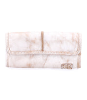 Meet Canton by Bed|Stü: a beige leather wallet featuring a fold-over flap and a small rectangular metal accent on the front bottom right corner. This versatile 2-in-1 design effortlessly transitions from wallet to clutch, offering you effortless style for any occasion.