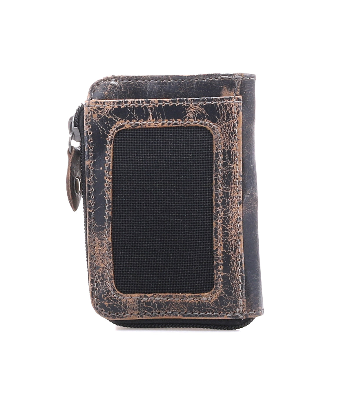 Introducing the Carrie by Bed|Stü—a compact brown leather wallet characterized by its gently worn finish and a distinctive black rectangular patch on the front. Designed for practicality, it features a convenient side zip compartment for secure storage and multiple card slots, all showcased against a crisp white background.