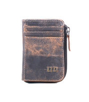 The Bed|Stü Carrie is a brown compact leather wallet featuring card slots, a zip compartment, and visible stitching, shown against a white background.