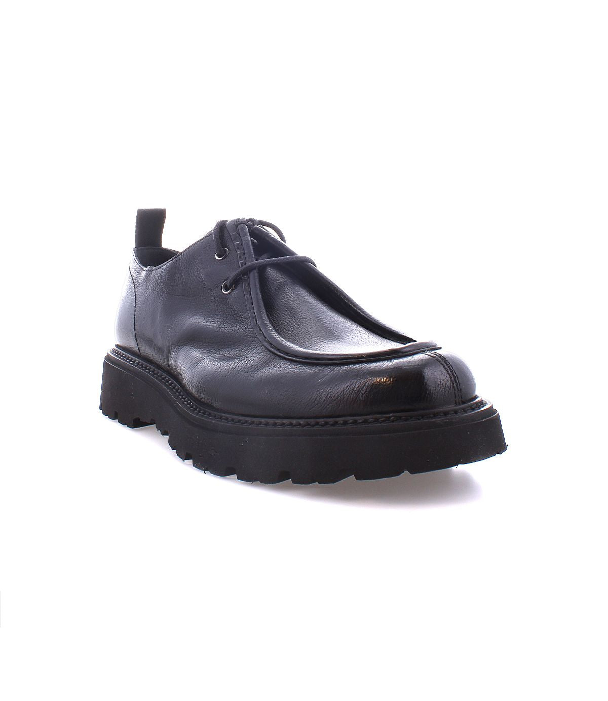 Introducing the Casotto by Bed|Stü: a single men’s moc-toe boot in black, crafted from expertly vegetable-tanned leather with a thick, rugged sole and lace-up closure, showcased against a white background.