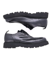 The Casotto by Bed|Stü is a pair of black lace-up shoes with thick, rugged soles, expertly crafted from premium vegetable-tanned leather and displayed side by side on a white background, exemplifying outstanding Italian craftsmanship.