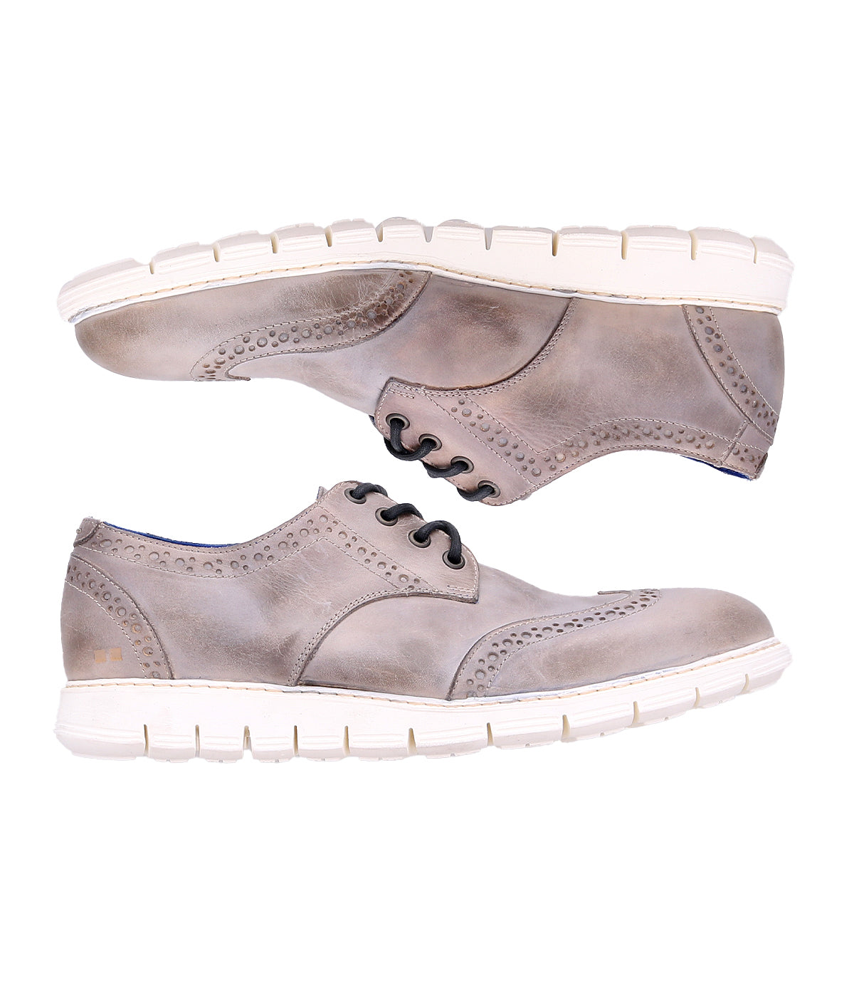 A pair of Bed|Stü Cayuga II light brown oxford dress shoes with brogue detailing and decorative perforations, featuring white rubber soles, displayed side by side in profile on a white background.