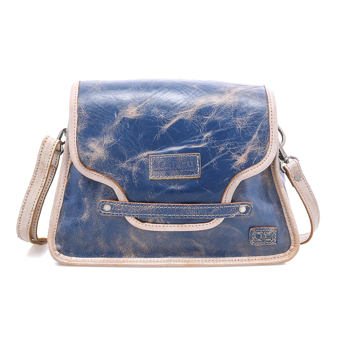 The Bed|Stü Ceremonious is a blue and tan leather preppy flap-top bag featuring visible stitching, an adjustable shoulder strap, and a magnetic closure. Its organized interior provides convenient storage for your essentials.