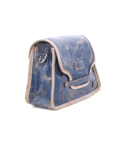 Ceremonious by Bed|Stü is a distressed blue leather satchel featuring beige trim, a front flap with a visible embossed logo, side metal ring, magnetic closure, and an organized interior—perfect for effortless everyday style.