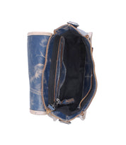 Top view of the Ceremonious handbag by Bed|Stü, an open blue leather flap-top bag showcasing its organized interior with visible compartments and a zippered pocket, set against a white background.