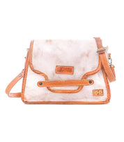 Introducing the Bed|Stü Ceremonious—a beige and brown leather crossbody bag featuring a front flap with vibrant orange trim, a convenient top handle, and an adjustable shoulder strap. This preppy flap-top bag combines effortless style and practicality with its organized interior and secure magnetic closure.