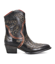 The Bed|Stü Chamise is a black leather western boot featuring brown detailing, decorative stitching, metal studs, and a short heel, displayed in side profile on a plain white background.
