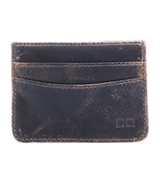 Presenting the Chuck by Bed|Stü—a black leather slim wallet featuring a well-worn finish with visible scratches and two front slots, displayed against a clean white background. Compact and durable, the Chuck is a practical choice for everyday use.