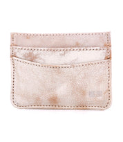 The Bed|Stü Chuck is a beige leather compact card wallet featuring visible stitching, two front slots, and a slightly worn, textured surface—an ideal slim option for your everyday carry.