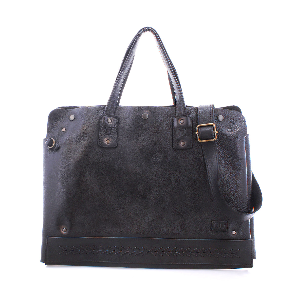 The Bed|Stü Commuter is a black leather bag featuring two handles, an adjustable shoulder strap, metal hardware, and decorative stitching along the bottom edge, displayed against a white background.