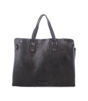 The Bed|Stü Commuter bag, featuring black textured leather, two sturdy handles, and sleek metal hardware in a rectangular silhouette, is ideal as a stylish laptop or mobile office bag and is showcased against a plain white background.