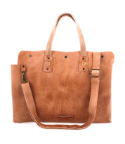 The Bed|Stü Commuter is a light brown leather bag featuring two top handles, a detachable shoulder strap, and striking metal hardware accents. Set against a white background, it serves perfectly as a stylish laptop bag or mobile office bag.
