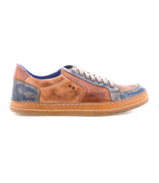 The Bed|Stü Condor sneaker features brown and blue leather with beige laces, white stitching, a durable rubber sole, and a blue inner lining for comfort. Shown in a left side view on a white background.