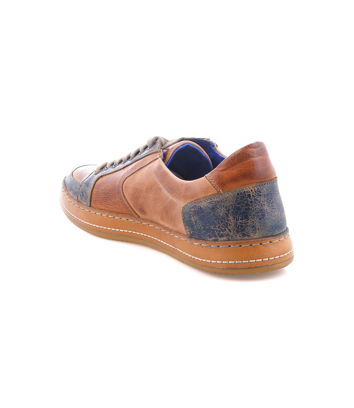 The Bed|Stü Condor is a brown and blue leather sneaker featuring durable construction and a textured heel, shown from the back left side against a white background.