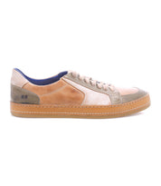 The Bed|Stü Condor is a casual, comfortable leather sneaker featuring a tan, beige, and olive green leather upper, beige laces, and a light brown rubber sole with durable construction. It is shown in side profile on a white background.