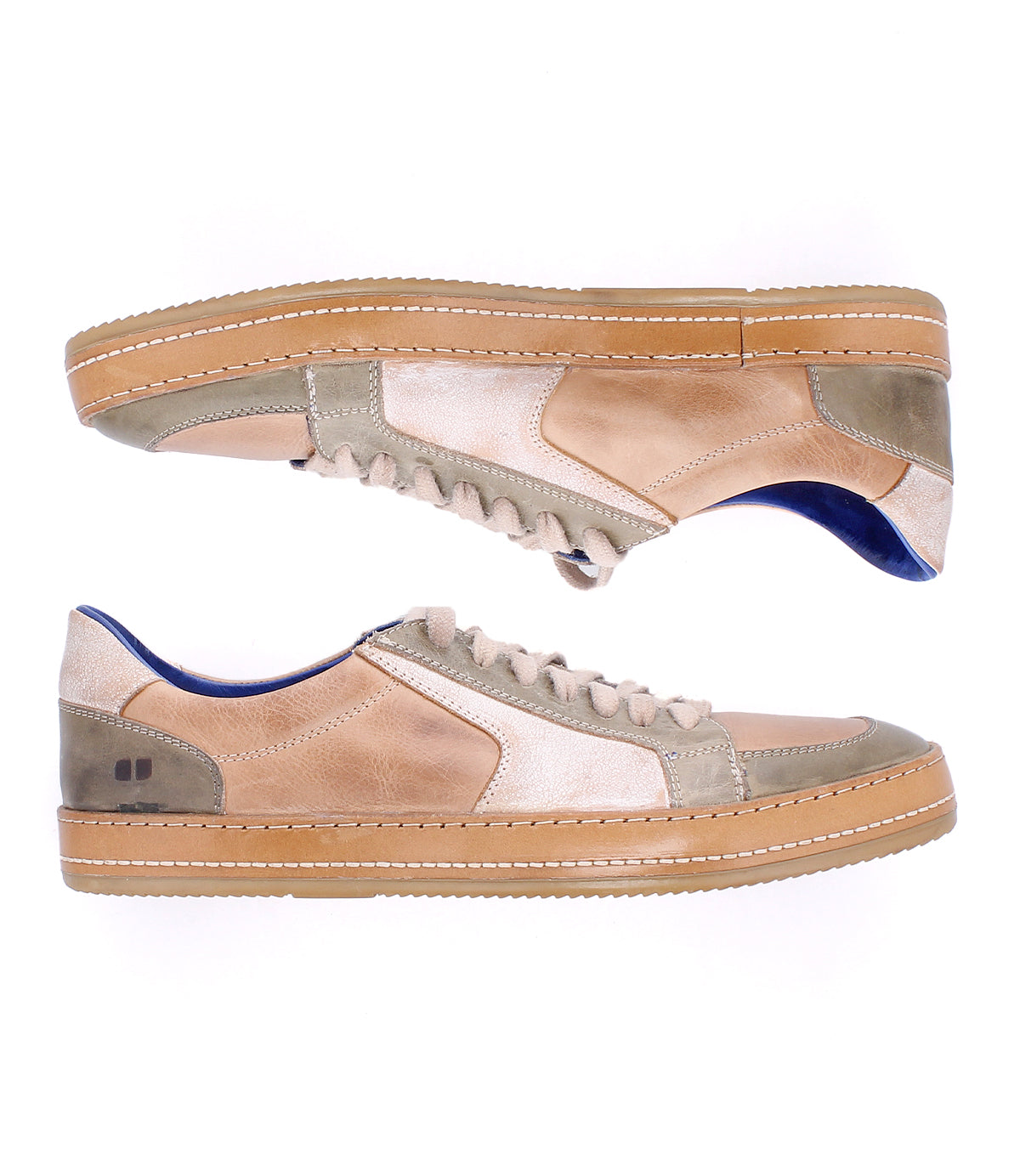 The Condor by Bed|Stü is a pair of low-top leather sneakers in beige and taupe, featuring gum rubber soles, blue inner lining, and detailed side stitching—displayed from the side against a white background. Crafted for comfortable wear and durable construction, these leather sneakers seamlessly blend style with practicality.