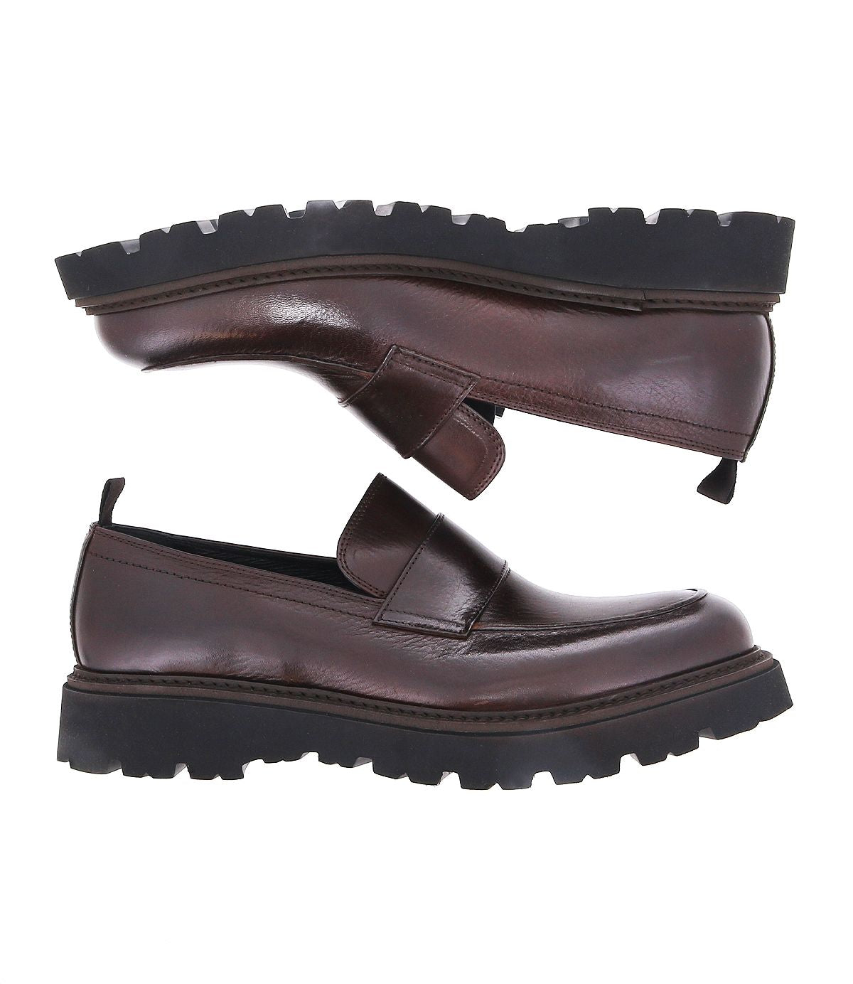 A pair of Costruito brown vegetable-tanned leather loafers by Bed|Stü, featuring thick black chunky Livetech outsoles—one shoe shown sole up above the other—displayed on a white background.