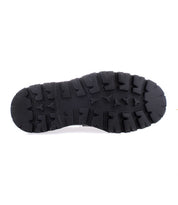 Black rubber Costruito shoe sole by Bed|Stü with deep, rugged treads, viewed from the bottom against a plain white background. This durable, chunky Livetech outsole adds a modern edge to the classic Italian-made penny loafer.