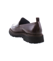The Costruito by Bed|Stü is an Italian-made penny loafer in brown vegetable-tanned leather, shown from the back left side with a chunky Livetech outsole against a white background.