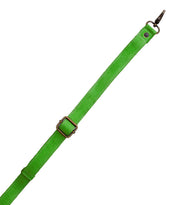 A vibrant green Crossbody Strap by Bed|Stü, crafted from adjustable leather and featuring a metal buckle and clasp, is displayed against a white background—ideal for crossbody wear or pairing with your favorite Bed|Stü bags.