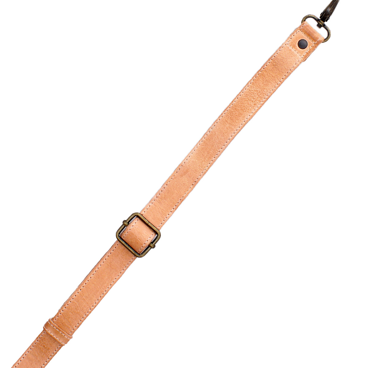 A tan leather Crossbody Strap by Bed|Stü, featuring an adjustable design with a metal buckle and a metal clasp at one end, is shown against a white background.